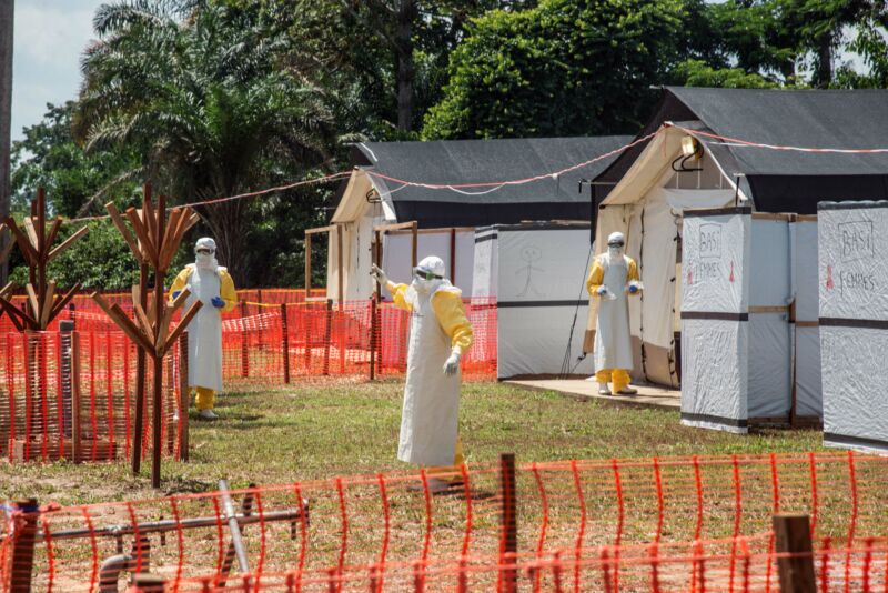 Health workers operate within an Ebola safety zone in the Health Center in Iyonda, near Mbandaka, on June 1, 2018. - The UN health agency and DRC authorities are rushing to contain the outbreak that has sickened 54 people in recent weeks, including 25 who have died. (Photo by Junior D. KANNAH / AFP) (Photo credit should read JUNIOR D. KANNAH/AFP via Getty Images)